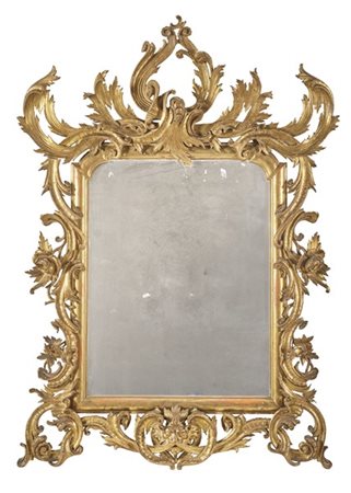 Specchiera di forma mossa con cornice in legno riccamente intagliato, traforato