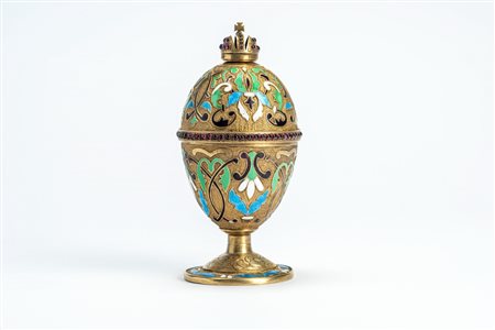 Uovo sormontato da corona in argento dorato, cesellato con smalti policromi cloisonné e guilloché e cabochon di paste vitree color rubino. Russia, fin […]