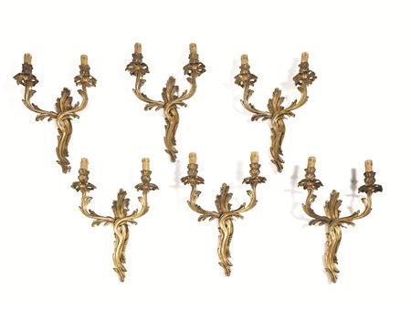 SEI APPLIQUES, FINE SECOLO XIXin bronzo dorato, ciascuno a due bracci...