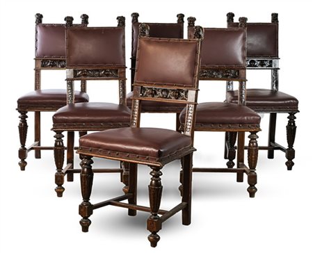 Gruppo di sei sedie neorinascimentali in legno tinto e intagliato con mascheron