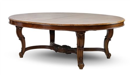 Tavolo allungabile di forma ovale in mogano con gambe mosse e scanalate raccord