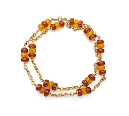 Lunga collana a laccio in oro e ambra policroma Oro giallo 750/000. Peso...