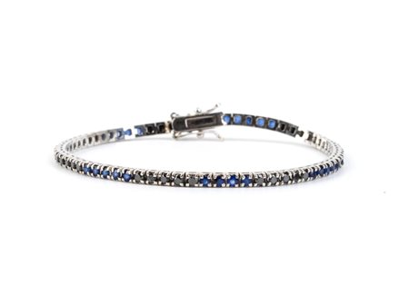  
Bracciale "tennis" in oro con con diamanti neri e zaffiri 
 