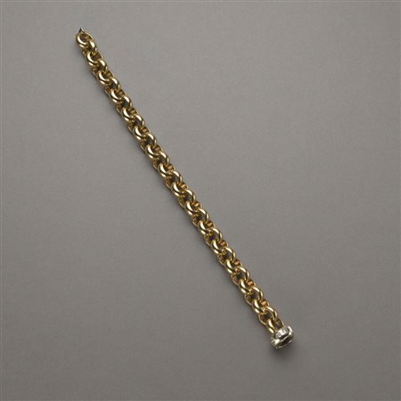 Bracciale rolò in oro giallo con chiusura in oro bianco, diamanti rotondi...