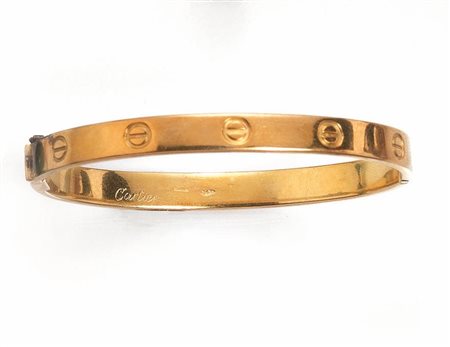 BRACCIALE, 'LOVE', CARTIER, IN ORO GIALLOa cerchio rigido ovale con motivi a...
