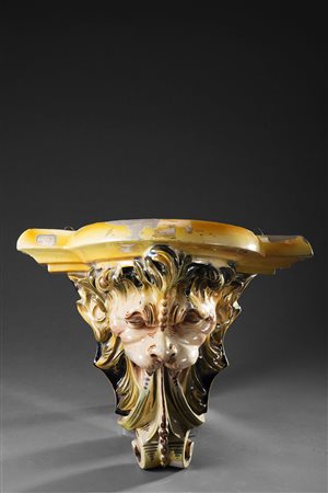 Coppia di mensole in ceramica policroma con teste di animali fantastici (cm...