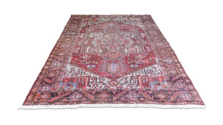 TAPPETO PERSIANO HERIZ fondo rosso, campo con medaglione centrale e motivi...