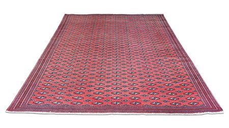TAPPETO PERSIANO TURCOMANNO TEKKÉ inizio del XX secolo fondo rosso, campo con...
