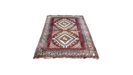 TAPPETO CAUCASICO fondo marrone, campo con due medaglioni centrali nei toni...