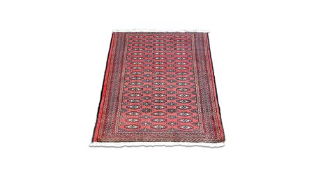 TAPPETO PERSIANO TURCOMANNO TEKKÉ fondo rosso, campo con motivi geometrici...