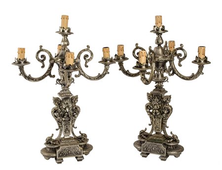 COPPIA CANDELABRI a cinque luci in metallo argentato riccamente lavorato....