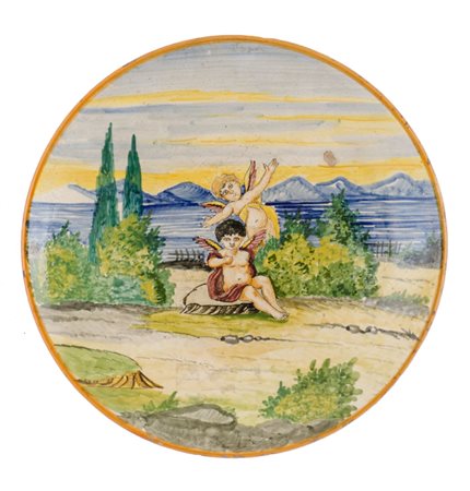 PIATTO in ceramica decorata e smaltata raffigurante "paesaggio con putti"....