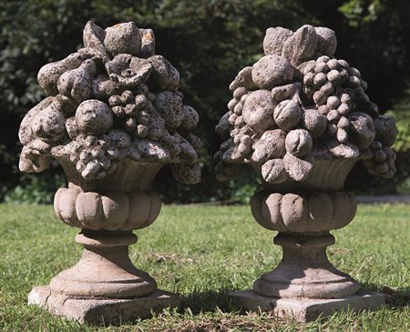 Coppia di elementi decorativi in pietra scoplita a forma di vasi con...