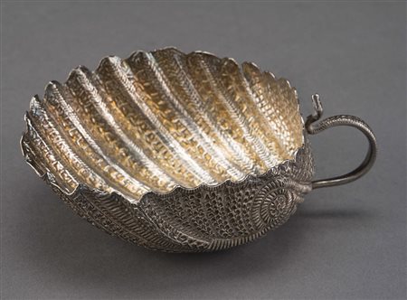 Alzata in argento a forma valva di conchiglia interamente sbalzato a motivi...