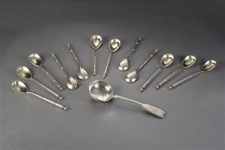 Gruppo di dodici cucchiaini e un colino in argento decorati a motivi...