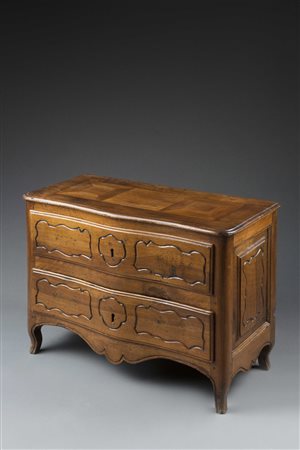 Modello di comò a due cassetti in noce, mosso sul fronte e decorato con...