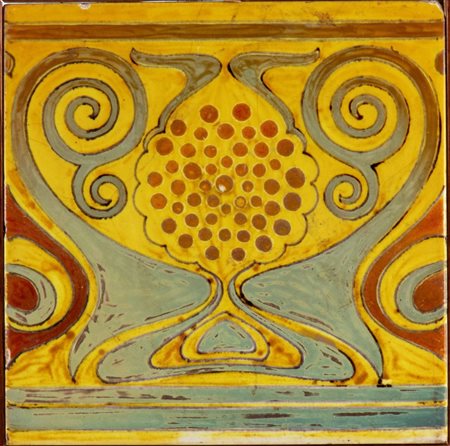 GALILEO CHINI (Firenze 1873 - 1956), Mattonella a decori gialli