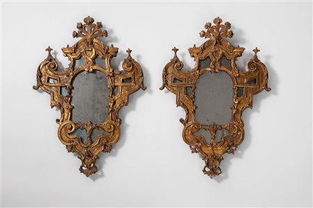 Coppia di specchiere di forma mossa con cornici in legno intagliato e dorato. Secolo XIX