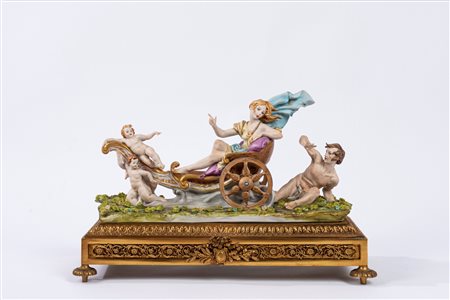 Gruppo in biscuit decorato in policromia, raffigurante il carro di Aurora