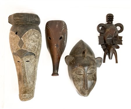 Arte Africana. Collezione di quattro maschere etniche in legno intagliato di mi