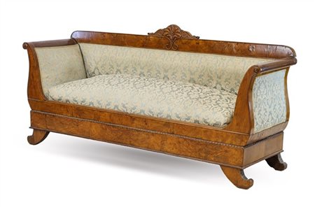 Divano a barca in noce e radica con cimasa intagliata a palmetta e piedi mossi.