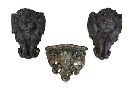 Lotto composto da coppia di antiche mensole in legno intagliato ed ebanizzato a