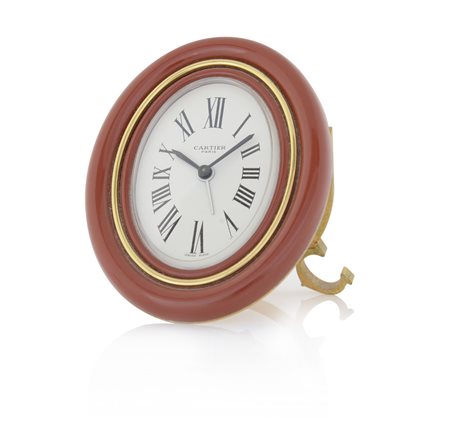 CARTIERCARTIER SVEGLIETTA ANNI '80.C. ovale in ottone dorato con cornice...