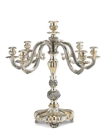 Candelabro a sette fiamme in argento sbalzato a volute e decori fogliacei, base