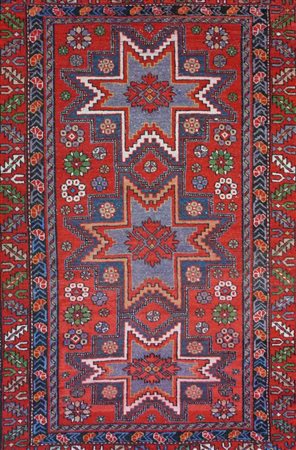 Tre stelle geometrizzate decorano il fondo rosso accompagnati da vari motivi...