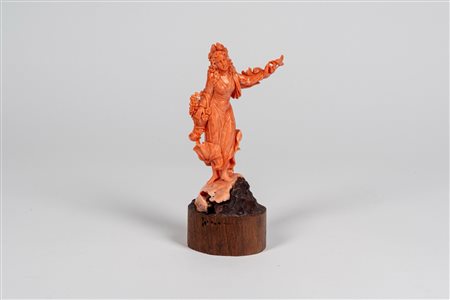 Scultura in corallo rosa intagliato e inciso raffigurante figura allegorica di fanciulla con cesto di fiori e colombi.  Italia meridionale, fine secolo XIX.