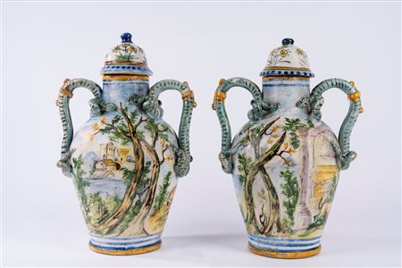 Coppia di vasi ad anfora con coperchio in maiolica policroma istoriata a scene mitologiche con anse serpentine. Manifattura dell’Italia meridionale, secolo XIX.