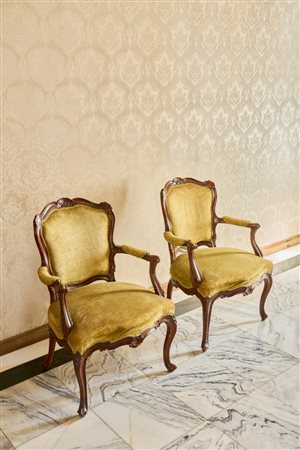 Coppia di poltrone in legno intagliato con braccioli mossi terminanti a ricciolo, schienale e grembiale centrati da valva di conchiglia. Veneto, secolo XVIII