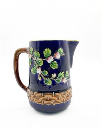 Versatoio in ceramica policroma con decorazione a rilievo a fiori e canestro su