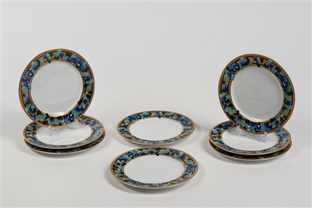 Pomellato, venti piattini da pane in porcellana con bordo dorato e policromo