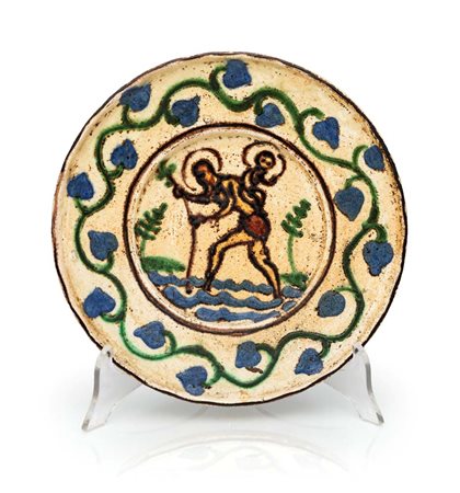 Piatto in maiolica decorata a zaffera in blu, verde ramina e manganese,...