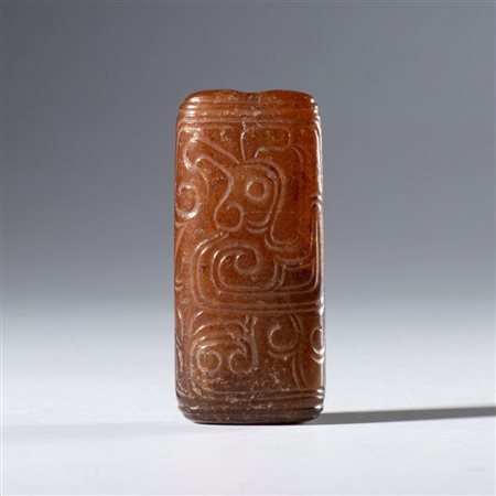  
Pendente tubolare in giada Hotan con figure schematizzate incise. Cina, dinastia Qing (1644-1912), XVIII secolo 
 mm 47.8 x 21.5 x 13