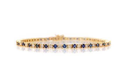 Bracciale tennis in oro, zaffiri e brillanti Oro giallo 750/000. Diamanti in...