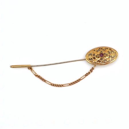 Spilla traforata in oro 18 kt e rubino
