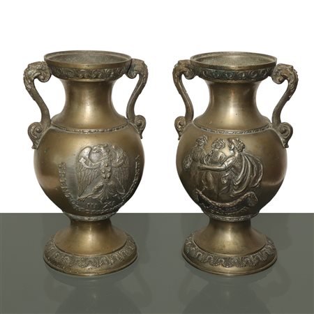 Coppia di vasi biansati in metallo con decori e iscrizioni a rilievo sul fronte e sul retro