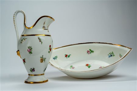 Versatoio con bacile ovale in porcellana, decorati in policromia a fiori e rametti sparsi con profili dorati. Francia, inizio secolo XIX
