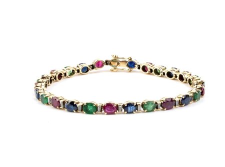 Bracciale tennis con rubini, zaffiri, smeraldi e diamanti In oro giallo 18k,...