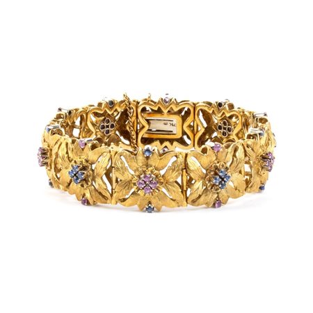 Bracciale floreale in oro con rubini e zaffiri Con linea di maglie snodate,...
