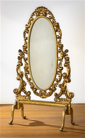 Psiche in legno intagliato e dorato con specchio ovale basculante e montanti a