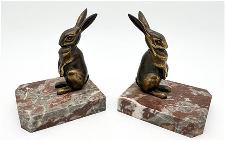 Coppia di fermalibri in marmo sormontati da figura di coniglio in bronzo a tutt