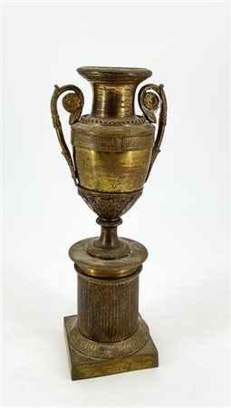 Vaso biansato in bronzo dorato su base a semicolonna scanalata e piede quadrato