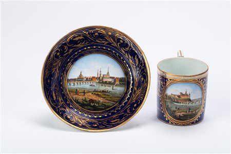 Tazza con piattino in porcellana policroma con vedute di Meissen e Dresda. Manifattura di Meissen, circa 1815