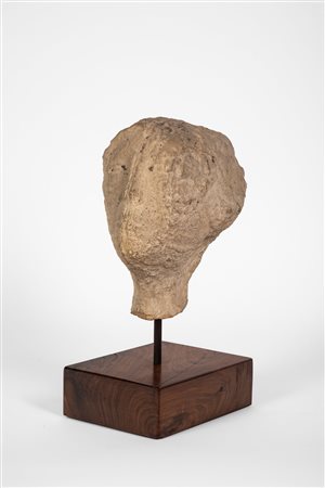 Testa in pietra scolpita raffigurante volto femminile.