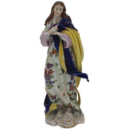 Madonna Piccola stauta in porcellana policroma con decoro a motivi floreali....