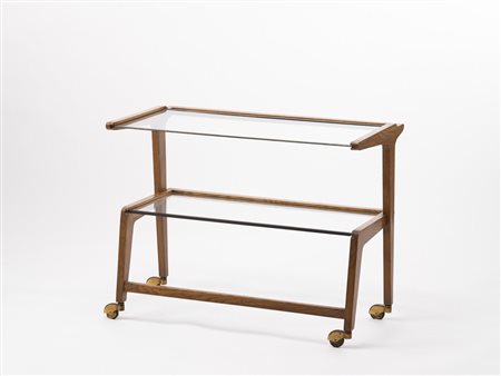 Carrello portavivande a due ripiani in cristallo con gambe munite di rotelle....