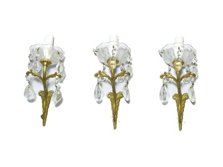 **DA BOLLARE 850. Serie di tre appliques in bronzo dorato A Set of Three...